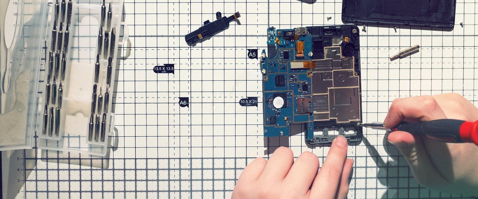 A phone being repaired at a workbench